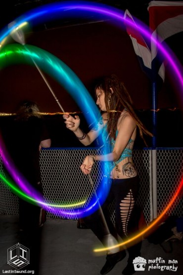 A guest spins LED poi on the top deck